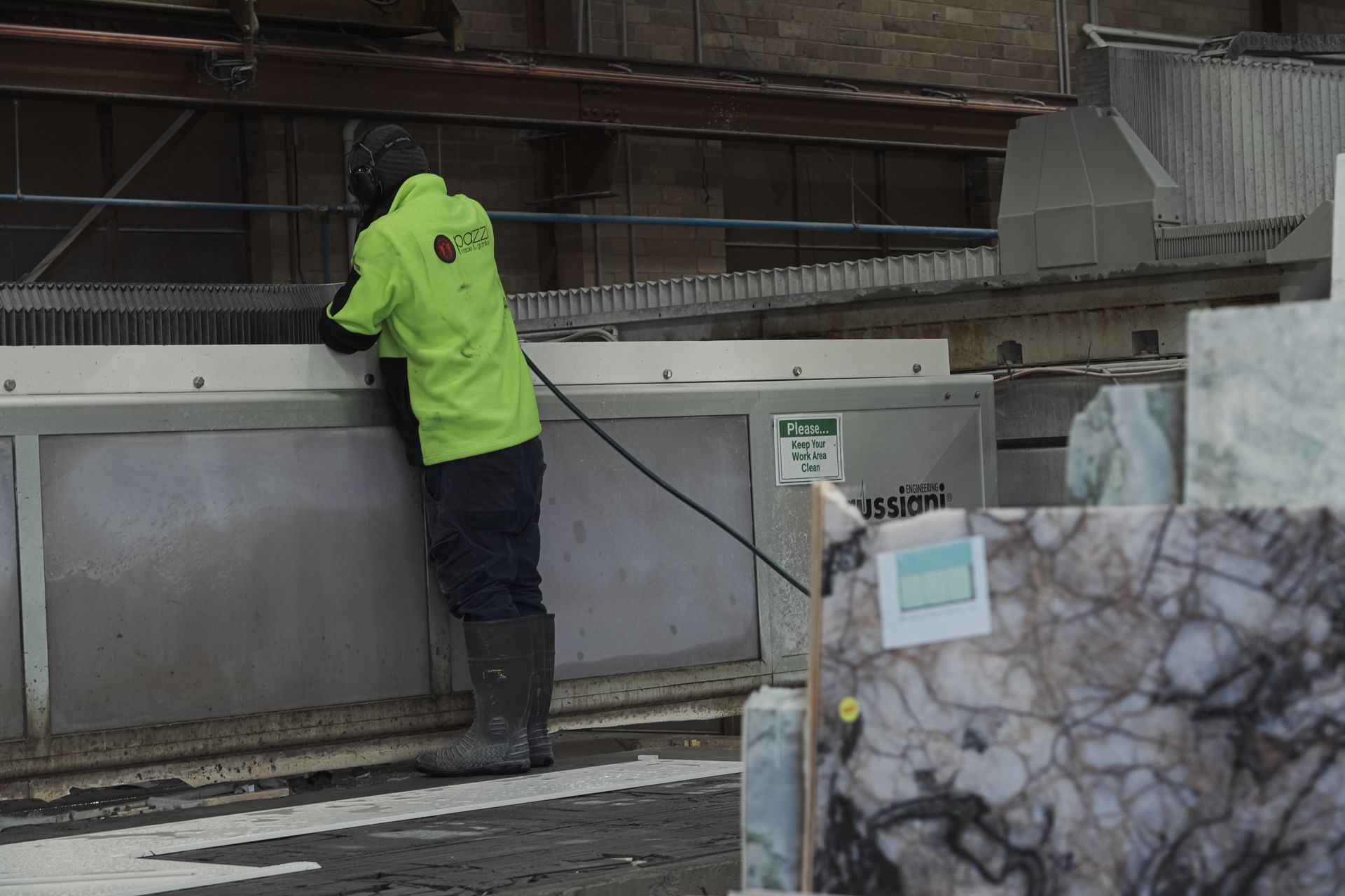 CNC router shaping marble for curved edges and mitred joins in high-end Melbourne home.