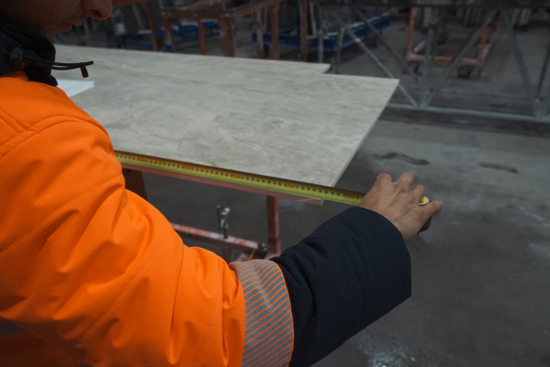 Artisan stonemason hand-finishing marble edges for flawless polish and tight tolerances.