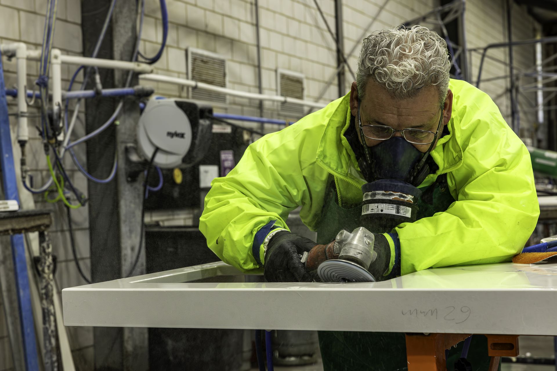 “Close-up of artisan stone polishing showing honed finish and precision detailing, Pazzi Marble & Granite workshop.”