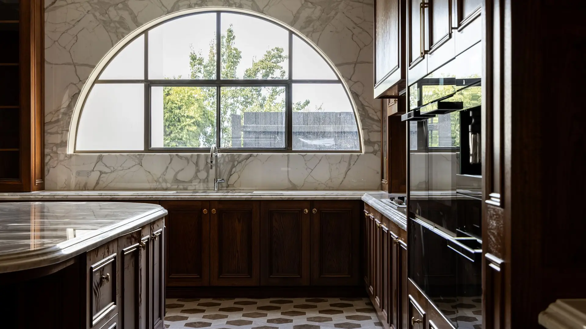 Floor-to-ceiling Calacatta marble wall panels with lambs-tongue profiles installed in Stonington Mansion.